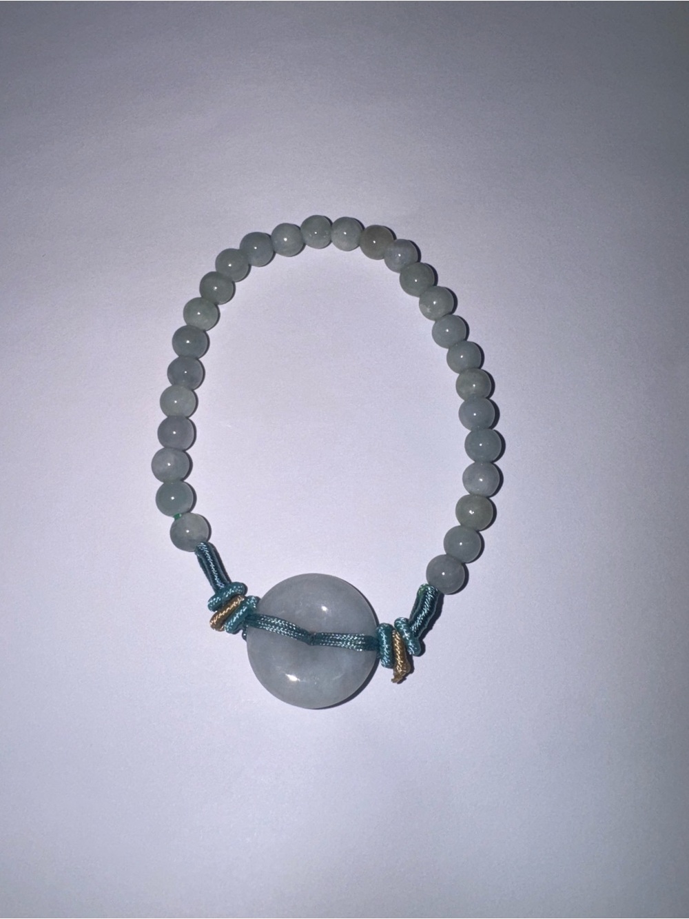 Handmade Light Green Jade Bead Bracelet with donut pendant.